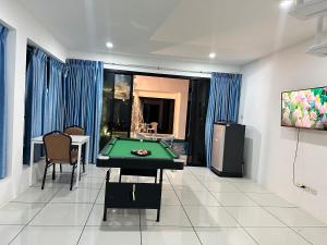 a living room with a pool table and a tv at Mona Lisa pool villa in Pattaya South