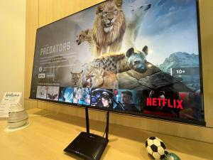 a flat screen tv with a movie on it at Netflix-Seaview-SunsetView-PuteriBeach-Mutiara Beach Resort Melaka in Kampong Pantai Dusun