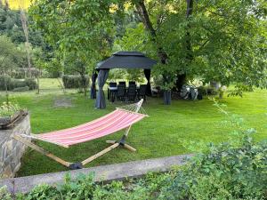 a hammock in a garden with a black tent at Villa Virginia in Broşteni