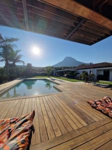 een houten terras met een zwembad in een huis bij The Pool house in La Farlède