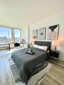 a bedroom with a large bed and a large window at High Rise Studio in Heart of Ktown DTLA in Los Angeles