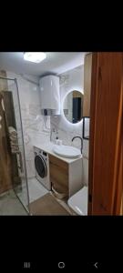 a bathroom with a sink and a mirror at Apartman Bagic in Zlatibor