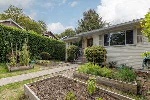 a garden in front of a house at Spacious Fully Furnished 2-BR Suite in Vancouver