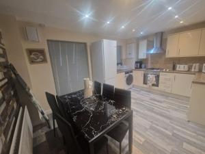 a kitchen with a table and a kitchen with white appliances at Getaway Haven 