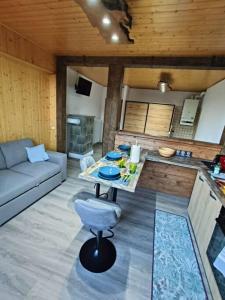 a living room with a table and a couch at Appartamento lake-side in Calceranica al Lago +17 photos