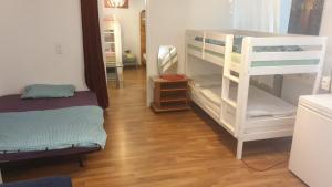 a room with two bunk beds and a wooden floor at Sweet home in Ludwigsburg