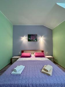 a bedroom with a bed with two towels on it at Apartments Korta in Račišće