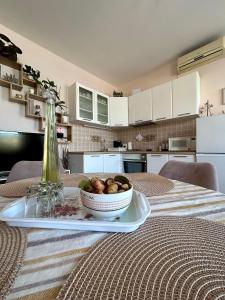 a table with a bowl of food on a table at Apartments Korta in Račišće
