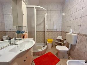 a bathroom with a sink and a toilet and a shower at Apartments Korta in Račišće