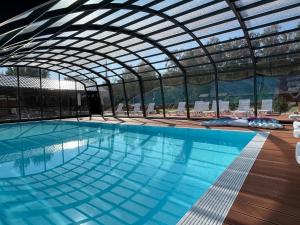 a large swimming pool with a retractable roof at Domki Zalesie in Jarosławiec