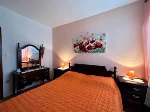 a bedroom with a bed and a sink and a mirror at Apartments Korta in Račišće