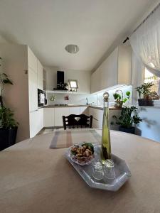 a bottle of wine and a bowl of food on a table at Apartments Korta in Račišće