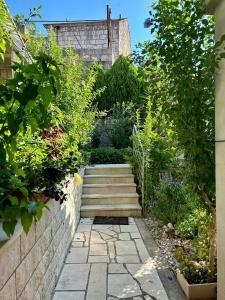 a garden with a stone wall and stairs at Apartments Korta in Račišće