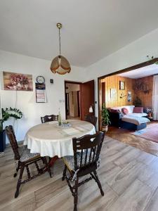 a dining room with a table and a living room at Apartments Korta in Račišće
