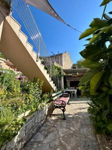 a bench sitting in the middle of a garden at Apartments Korta in Račišće
