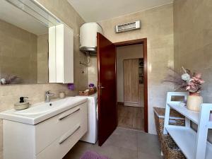 a bathroom with a sink and a mirror at Apartments Korta in Račišće