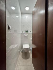 a bathroom with a toilet and a glass door at Apartments Korta in Račišće