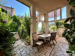 a patio with a table and chairs and some plants at Apartments Korta in Račišće