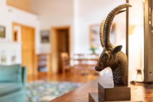 a statue of a ram on a table in a room at Chalet Windegg in Sankt Anton am Arlberg