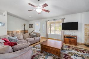 a living room with a couch and a flat screen tv at Fisherman's Cove Retreat - Game Room Included! home in Groveland