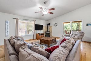 a living room with a couch and a ceiling fan at Fisherman's Cove Retreat - Game Room Included! home in Groveland