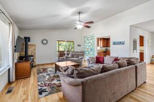 a living room with a couch and a ceiling fan at Fisherman's Cove Retreat - Game Room Included! home in Groveland