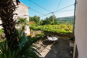 a view of a patio with a table and plants at Villa Marisan in Bribir