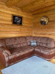 a living room with a couch in a log cabin at Садиба Краєвських in Krapivnik