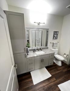 a bathroom with a sink and a toilet and a mirror at 1 BR w Balcony View Resort Pool Free Parking in Addison