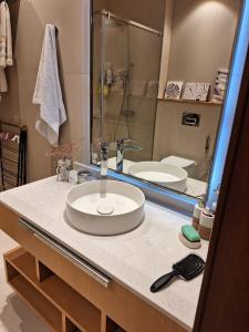 a bathroom counter with a sink and a mirror at Sea Breeze White Villas 2 in Bilgah