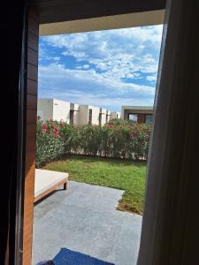 a view of a garden from the outside of a house at Sea Breeze White Villas 2 in Bilgah