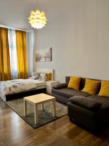 a living room with a couch and a coffee table at Ametyst Hostel in Krakow