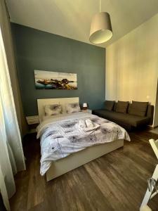 a bedroom with a bed and a couch at Ametyst Hostel in Krakow