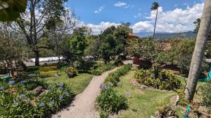 a garden with flowers and trees and a train at Coronel's Peak Coffee House in Salento