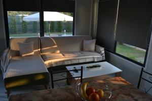 a living room with a couch and a table at Oneiropagida House in Sarti +5 photos