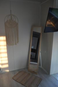 a mirror sitting on the floor next to a wall at Oneiropagida House in Sarti