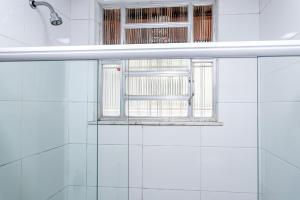 a bathroom with a window and a bath tub at Temporada Bacana - Copacabana e Conforto in Rio de Janeiro