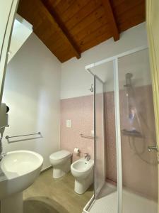 a bathroom with a toilet and a sink and a shower at Due Passi B&B in Marano Marchesato