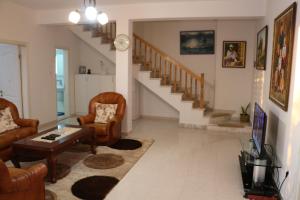 a living room with chairs and a table and a staircase at Villa Duka in Krujë