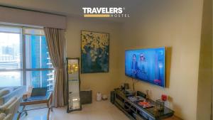 a living room with a flat screen tv on the wall at Travelers - Dubai Marina Hostel in Dubai