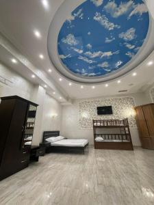 a bedroom with a ceiling with a blue sky at Dostoevsky Hotel Աղ ու Հաց FOOD COURT in Pʼarakʼar