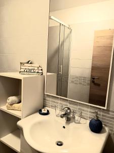 a bathroom with a sink and a mirror at Apartment Cetina in Ičići