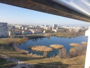 a view of a lake with grass islands in it at Apartment near to airport in Sofia