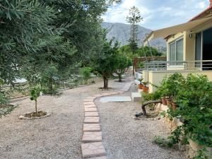a garden with a path leading to a house at Blue Flag Award Winning Beach: Home 2 in Vrontados