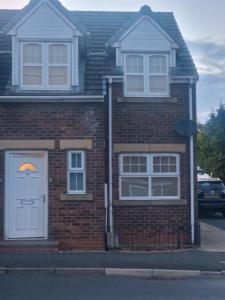 a brick house with a white door and windows at Getaway Haven 