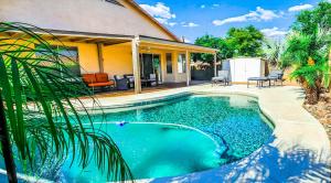 a swimming pool in front of a house at North Phoenix At Your Fingertips in Phoenix