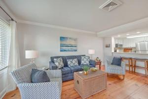 a living room with a blue couch and two chairs at New Listing! Port O' Call E203-Luxury Ocean View! in Isle of Palms