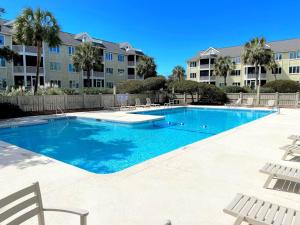 a large swimming pool in a apartment complex at New Listing! Port O' Call E203-Luxury Ocean View! in Isle of Palms
