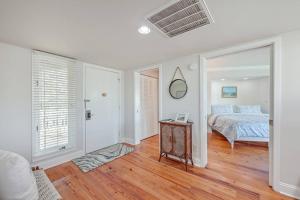 a white bedroom with a bed and a table at New Listing! Port O' Call E203-Luxury Ocean View! in Isle of Palms