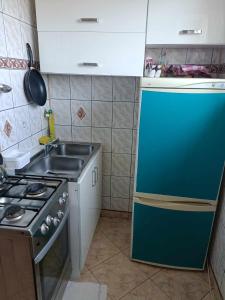 a small kitchen with a stove and a sink at Suchedniów mieszkanie in Suchedniów